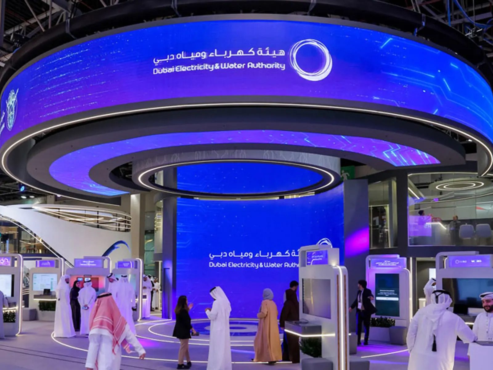 Custom exhibition stand designed and built by AURA 919 in Dubai — large island booth with LED lighting and branded graphics